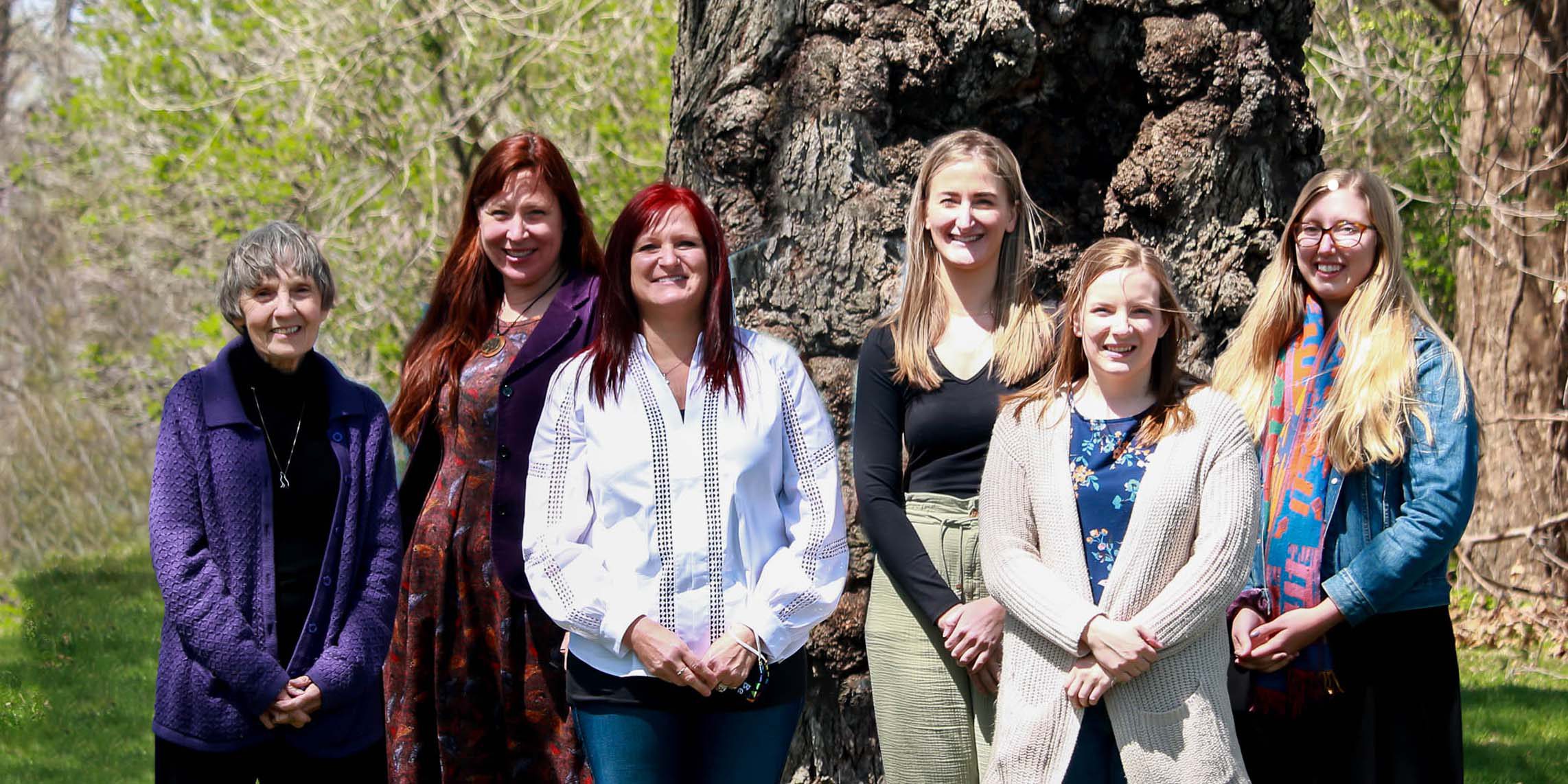 Staff in front of the Mother Tree at the Waterloo, IA location